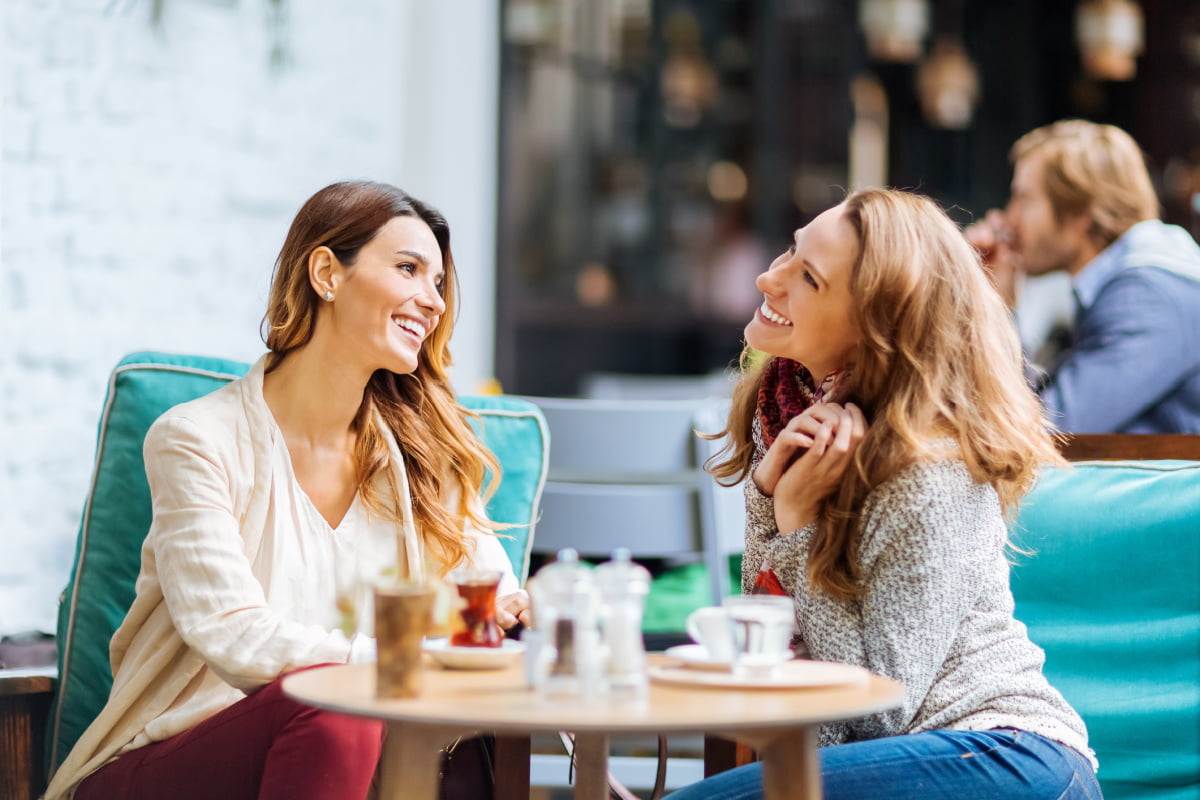 Women Enjoying Lunch and Coffee Outside at a Restaurant