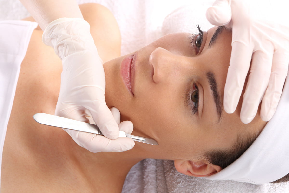 Woman getting a dermaplaning treatment at a med spa